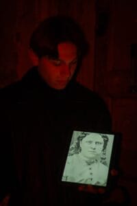 Jack the Ripper tour guide presenting historical victim photograph during Whitechapel walking tour