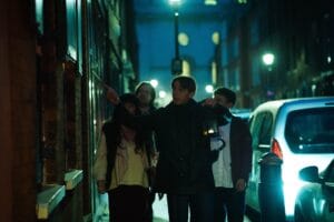 Jack the Ripper walking tour group exploring London night streets in Whitechapel