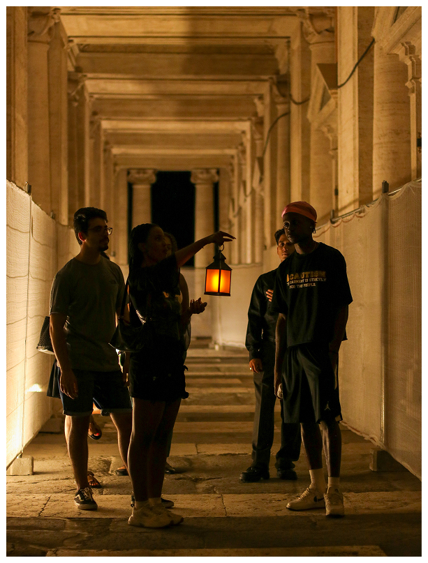 Jack the Ripper tour group walking through the atmospheric streets of Whitechapel at night
